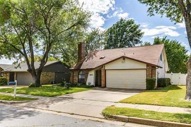 View of front of house featuring a garage and a front lawn