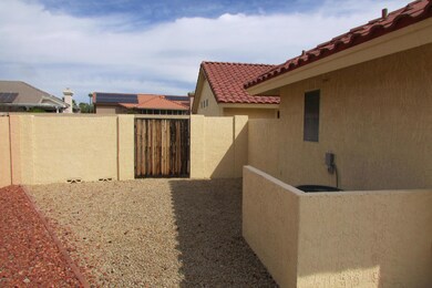 Side yard has wide gate