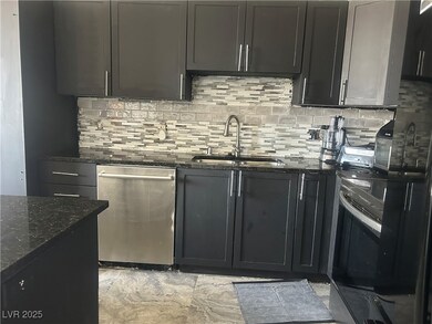 Kitchen featuring decorative backsplash, dark ston