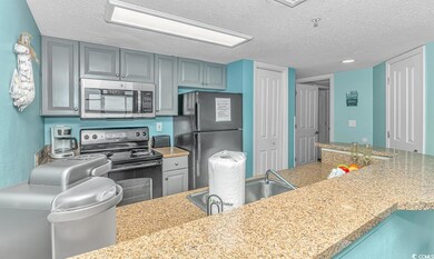Kitchen featuring light stone countertops, a textu