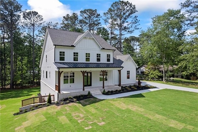 Modern farmhouse featuring a standing seam roof, c