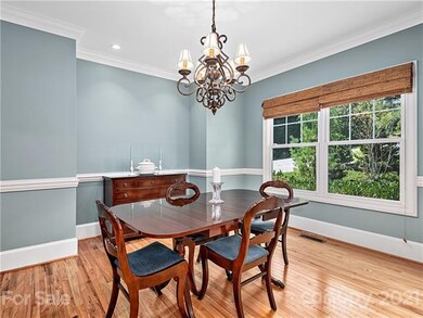 Dining Room with crown molding and chair railing.