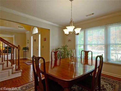 Dining Room. Hardwood floors continue into dining room with updated lighting.