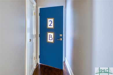 Vestibule to 2B with glass address windows that le
