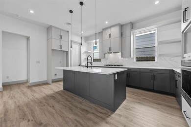Kitchen with sink, decorative light fixtures, ligh