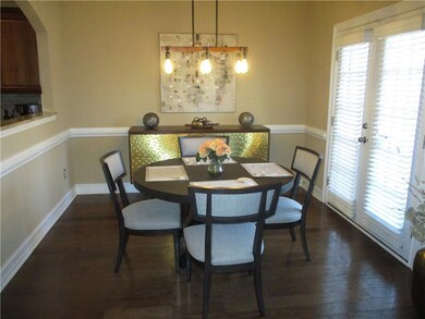 Dining area featuring baseboards and dark wood fin