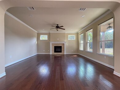 Unfurnished living room with visible vents, ornam