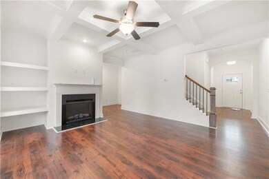 Unfurnished living room featuring coffered ceiling