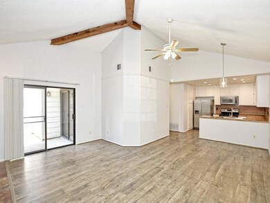 Unfurnished living room featuring a ceiling fan, 