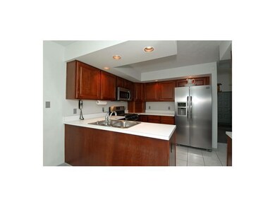 Kitchen. CHERRY CABINETRY,NEUTRAL CERAMIC,NEW STAI