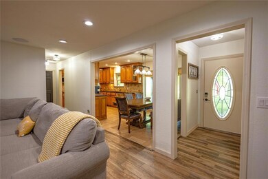 Entry shown on the right with the dining, kitchen,
