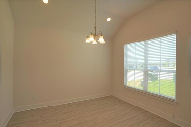 Empty room with a chandelier, light wood-type flo