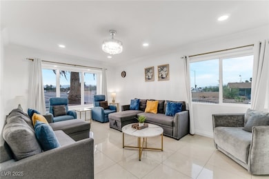 Living area with recessed lighting, light tile patterned floors, and a chandelier
