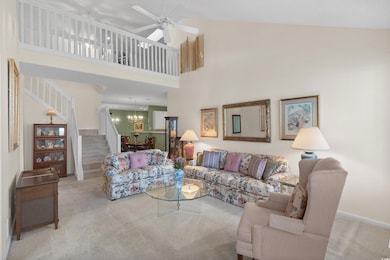 Living room featuring carpet floors, high vaulted 