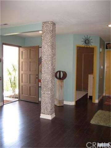 Front door and entry to downstairs bedroom