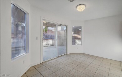 Spare room featuring baseboards and light tile pat
