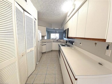Kitchen featuring white cabinetry, white appliance