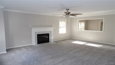 Unfurnished living room featuring crown molding, b