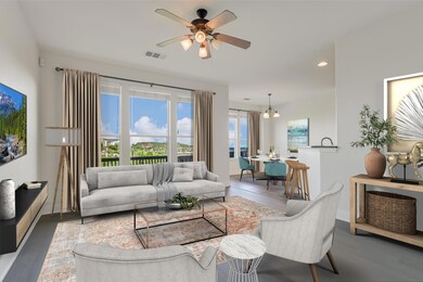 Living room featuring a ceiling fan, wood finishe