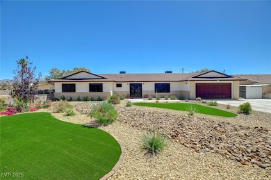 Single story home with driveway, a garage, and a front lawn