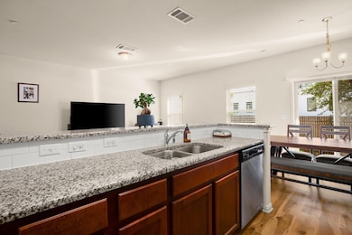Kitchen with stainless steel dishwasher, light wo