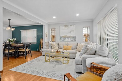 Large living room highlighted by coved ceilings, r