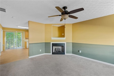 Unfurnished living room with ceiling fan, hardwood