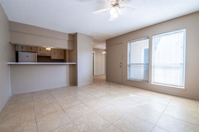 Unfurnished living room with baseboards, a ceiling