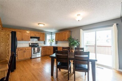 Spacious kitchen offers a large eat-in area plus access to the deck and backyard