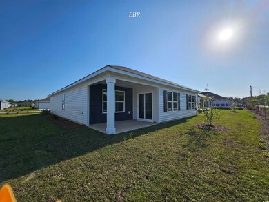Back of house featuring a yard and a patio