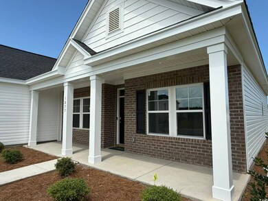 View of front of home featuring brick siding and a porch