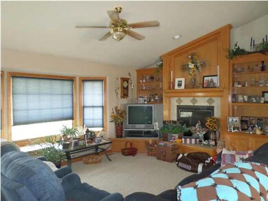 VAULTED LIVING ROOM WITH TWO WAY FIREPLACE.