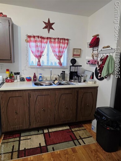 Kitchen featuring dark wood finished floors and light countertops