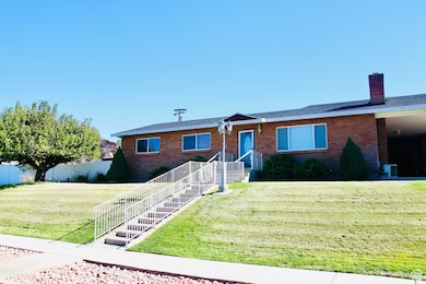 Single story home featuring brick siding and a chimney