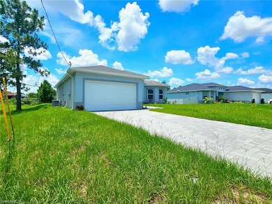 View of front facade featuring concrete driveway, a garage, a front lawn, and stucco siding