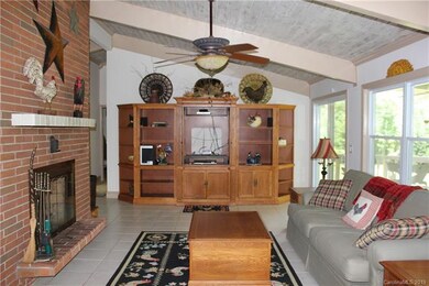 Main level living room with vaulted ceiling, tile 