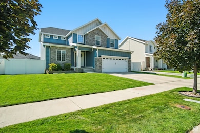 Craftsman inspired home featuring board and batten siding, concrete driveway, and stone siding