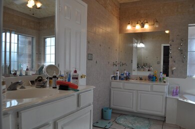 Bathroom featuring tile walls, a bath, tile floors