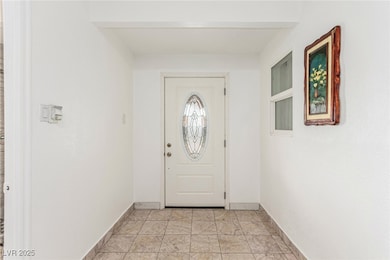 Foyer entrance featuring baseboards