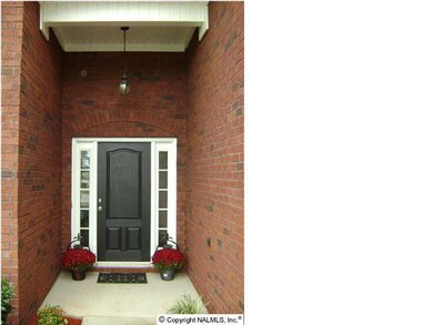 A COVERED FRONT PORCH TO WELCOME FAMILY AND FRIENDS.