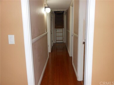 Hallway With Access To Attic Storage