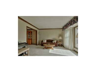 Large formal living room w/bay window & crown mold