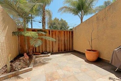 Private patio with slate flooring and palm tree