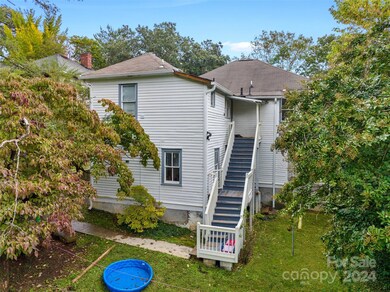 Rear of property with rear entrance to upper level units