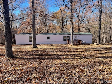 Back of property with a metal roof