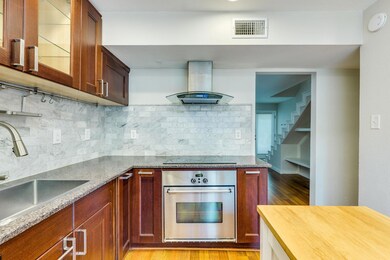 Kitchen with stainless steel oven, island range h