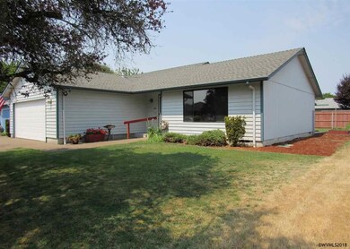 Grass front yard, window to living room, side bark