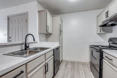 Kitchen with electric range, light wood-type floor