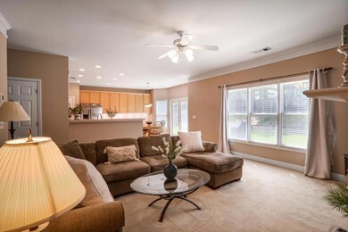 From the family room, enjoy an open view into the kitchen, enhanced by abundant natural light streaming in from the backyard, creating a warm and inviting atmosphere