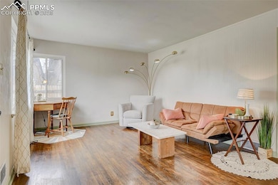 Living room with wood finished floors and baseboar